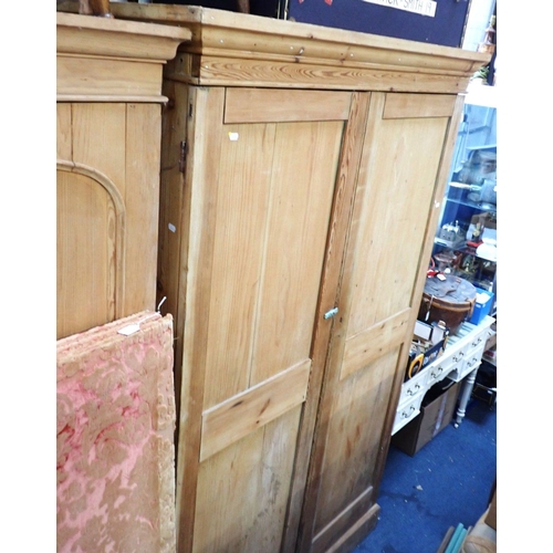 919 - A LARGE VICTORIAN STRIPPED PINE LINEN CUPBOARD with panelled doors and shelved interior 214cm high, ... 