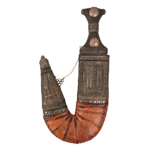 191 - A YEMENI JAMBIYA

late 19th century, with curved blade, wooden and decorated white metal-mounted gri... 