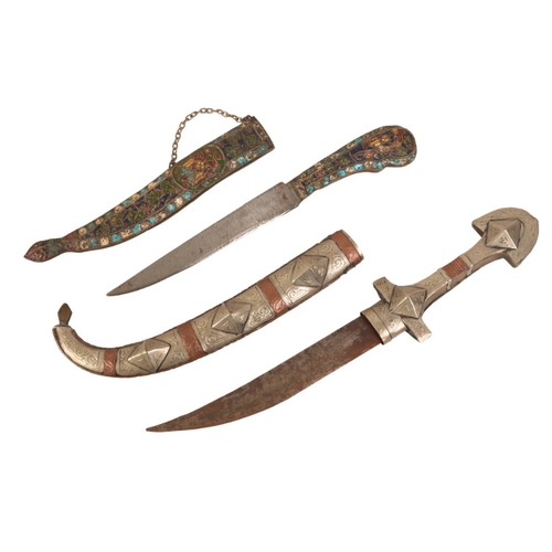 195 - A JAMBIYA

with a curved blade, silver and copper banded grip, in the original silver and copper ban... 