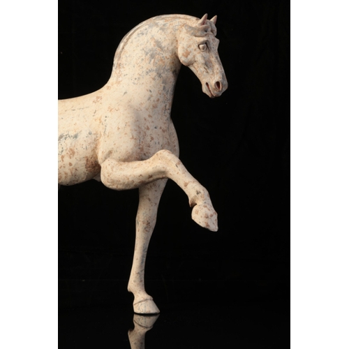 18 - A CHINESE POTTERY PRANCING HORSE

Tang, the sensitively modelled animal with raised hoof and well-de... 