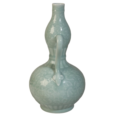 48 - A FINE CHINESE CELADON DOUBLE BALUSTER VASE

with finely carved decoration of lotus flowers and feat... 