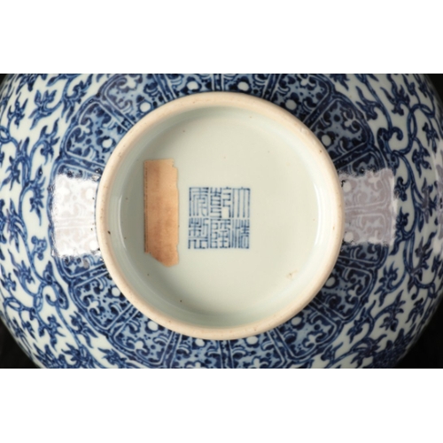 53 - A CHINESE BLUE AND WHITE BOWL

with heaped and piled decoration of lotus flowers and scrolls above a... 