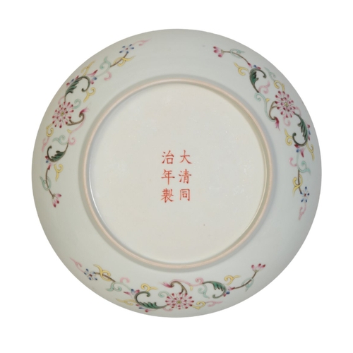 74 - A CHINESE FAMILLE ROSE PLATE

the centre with a panel of stylised flowers and scrollwork in shades o... 