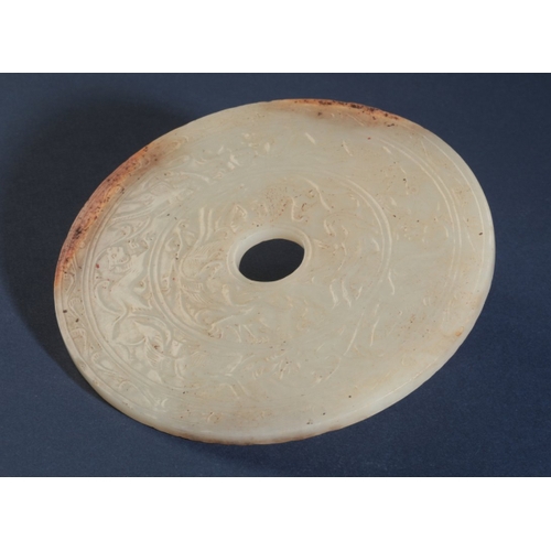 79 - A CHINESE WHITE JADE BI DISC

carved with two registers of phoenix, lions and other beasts within an... 