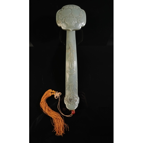 88 - A LARGE CHINESE JADE RUYI SCEPTRE

the head carved with peaches and blossom in a vase and the handle... 