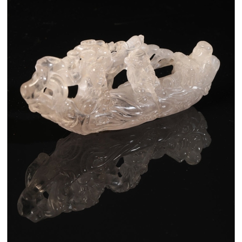 91 - A CHINESE ROCK CRYSTAL GROUP

probably Qing, of figures in a boat with vegetation beyond and waves l... 