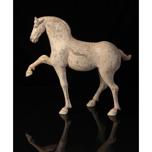 18 - A CHINESE POTTERY PRANCING HORSE

Tang, the sensitively modelled animal with raised hoof and well-de... 