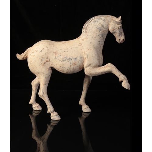 18 - A CHINESE POTTERY PRANCING HORSE

Tang, the sensitively modelled animal with raised hoof and well-de... 