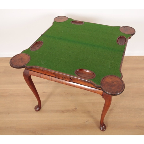 507 - A GEORGE II FIGURED WALNUT CARD TABLE

the hinged lid opening to baize lining shaped with oval cut o... 