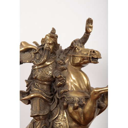 526 - A CHINESE GILT BORNZE FIGURE OF GUAN YU

20th century, cast astride a rearing horse, on a naturalist... 