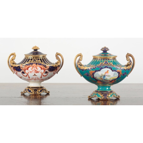 570 - TWO ROYAL CROWN DERBY BONE CHINA TWO-HANDLED URNS

of scrolled oval shape, one turquoise ground with... 