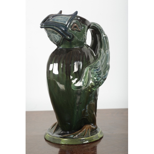 588 - C. H. BRANNAM: A BARUM ART POTTERY 'GROTESQUE BIRD' JUG

majolica glazed in green and blue, modelled... 