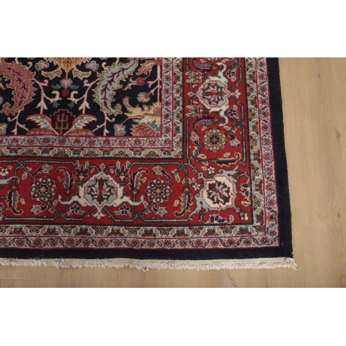 593 - AN ANTIQUE PERSIAN TABRIZ CARPET

woven in colours with endless leaf repeat on a dark blue ground, s... 