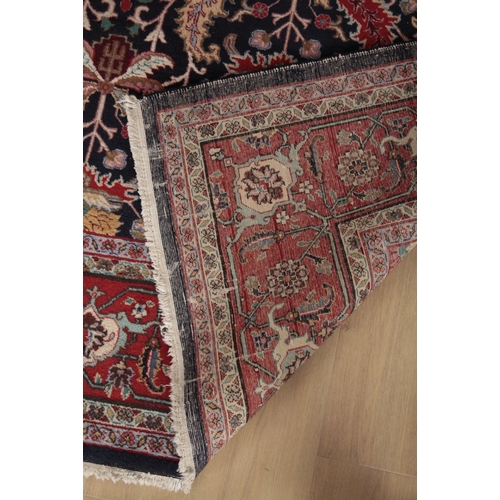 593 - AN ANTIQUE PERSIAN TABRIZ CARPET

woven in colours with endless leaf repeat on a dark blue ground, s... 