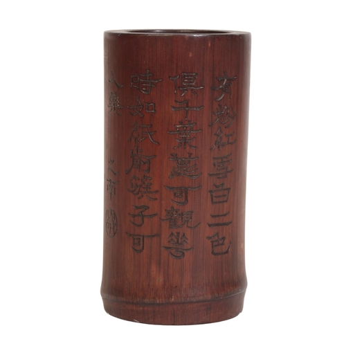 642 - A CHINESE BAMBOO BRUSH POT

carved with a seated figure in a rectangular panel with re-entrant corne... 