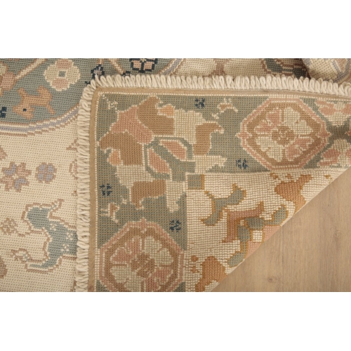 648 - A 'PORTUGUESE' FLAT STITCH RUG

20th century, the light ground with two contrasting floral medallion... 