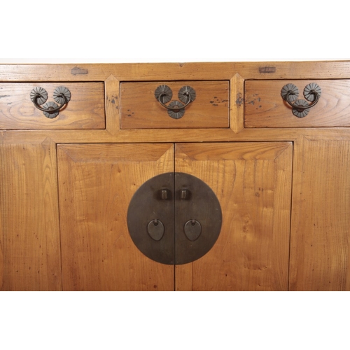 849 - A CHINESE ELM SIDE CABINET

20th century, with three short drawers over a cupboard, opening to a she... 