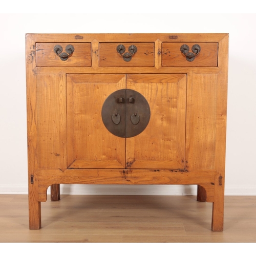 849 - A CHINESE ELM SIDE CABINET

20th century, with three short drawers over a cupboard, opening to a she... 