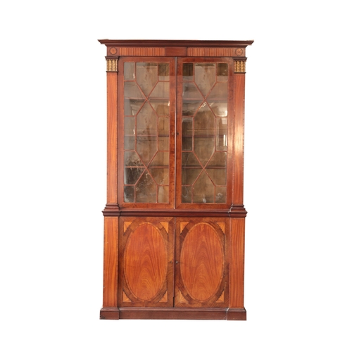 855 - A GEORGE III MAHOGANY AND SATINWOOD LIBRARY BOOKCASE

in the manner of Thomas Sheraton, the upper se... 