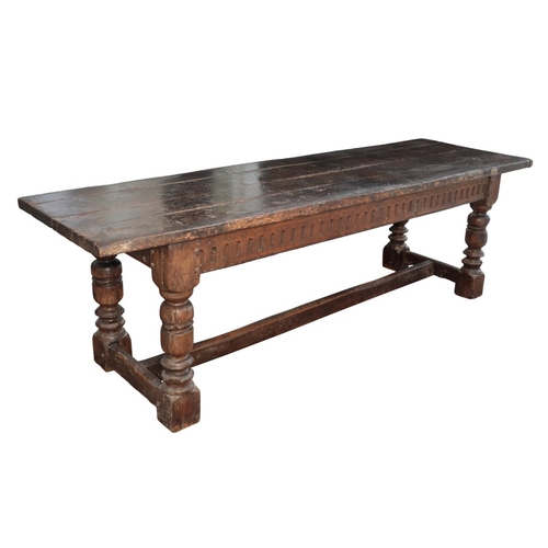 998 - AN OAK REFECTORY TABLE

16th century and later, the four plank top over a fluted frieze, on turned l... 