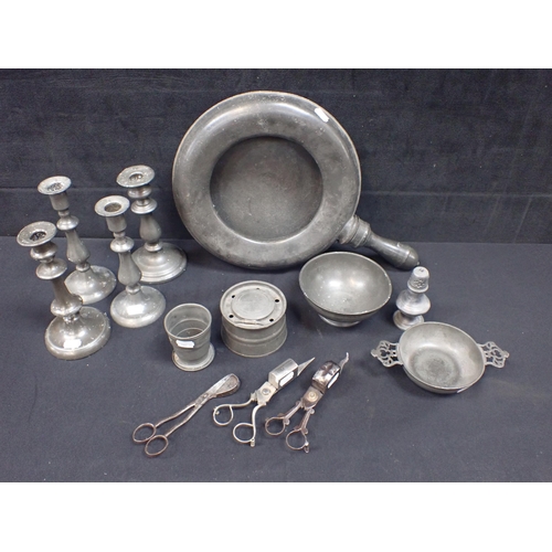 112 - A COLLECTION OF OLD PEWTER including a pair of candlesticks, others (and various steel snuffers), a ... 