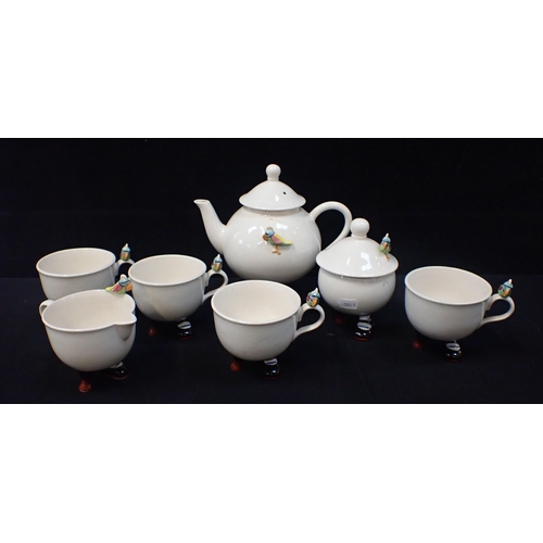 129 - A CARLTONWARE NOVELTY POTTERY TEA SERVICE modelled with feet and peg legs, comprising four cups, t... 