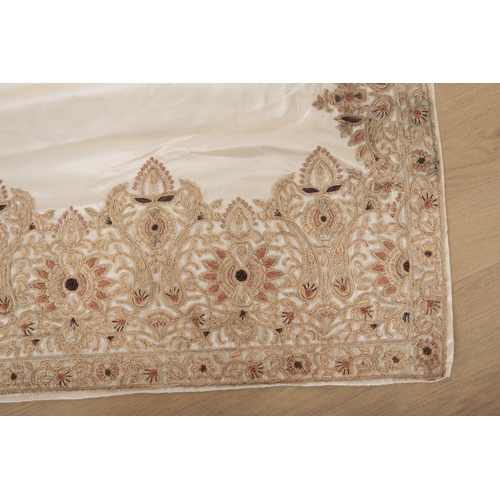 178 - AN INDIAN SARI, IVORY SILK WITH HEAVILY EMBROIDERED BORDERS 110cm wide, purchased in India for a wed... 