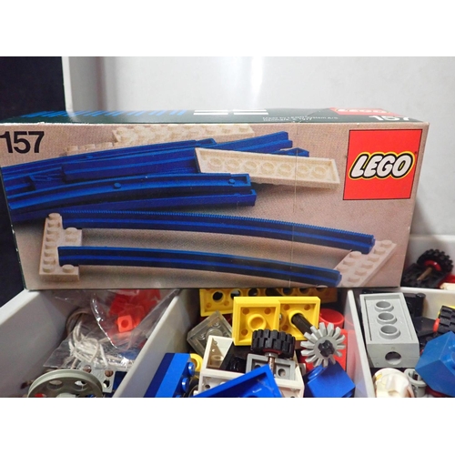 210 - A QUANTITY OF VINTAGE LEGO including an unopened box of blue rails (No.157), a yellow clockwork moto... 