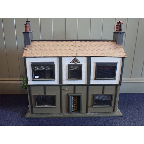 225 - A RESTORED AND FURNISHED DOLLS HOUSE with 'half-timbered' details c. 1930s 76cm wide