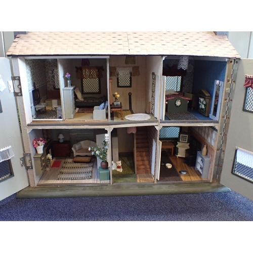 225 - A RESTORED AND FURNISHED DOLLS HOUSE with 'half-timbered' details c. 1930s 76cm wide