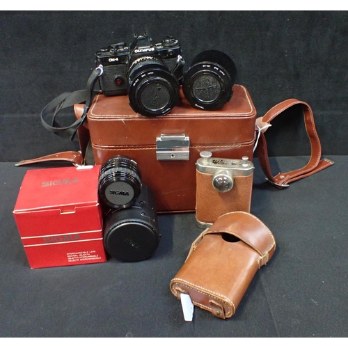 268 - AN OLYMPUS OM-4 35MM SLR CAMERA with two Tonkina lenses and a Sigma 28mm lens, contained in brown le... 