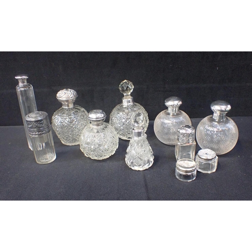 269 - A PAIR OF SILVER MOUNTED CUT GLASS PERFUME BOTTLES with other silver and white metal mounted scent b... 