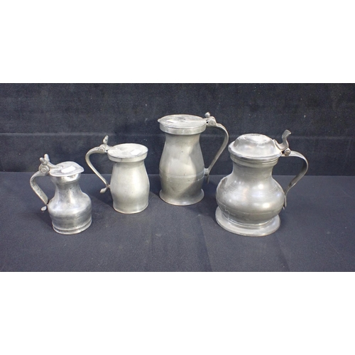 68 - FOUR ANTIQUE PEWTER LIDDED TANKARDS of bellied or baluster shape, varying size, largest 18cm high (4... 