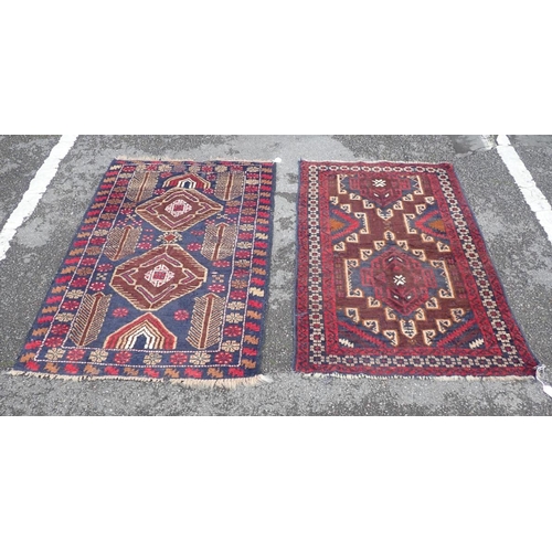 866 - TWO BELOUCHI RUGS EACH WITH LOZENGE MEDALLIONS 140 x 86cm and 136 x 80cm (both moth damaged) (2)