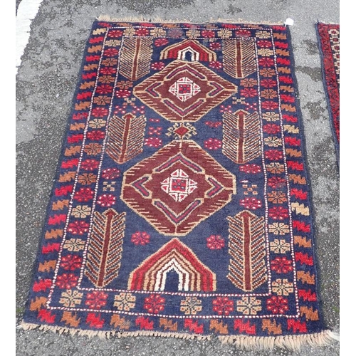 866 - TWO BELOUCHI RUGS EACH WITH LOZENGE MEDALLIONS 140 x 86cm and 136 x 80cm (both moth damaged) (2)