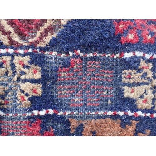 866 - TWO BELOUCHI RUGS EACH WITH LOZENGE MEDALLIONS 140 x 86cm and 136 x 80cm (both moth damaged) (2)