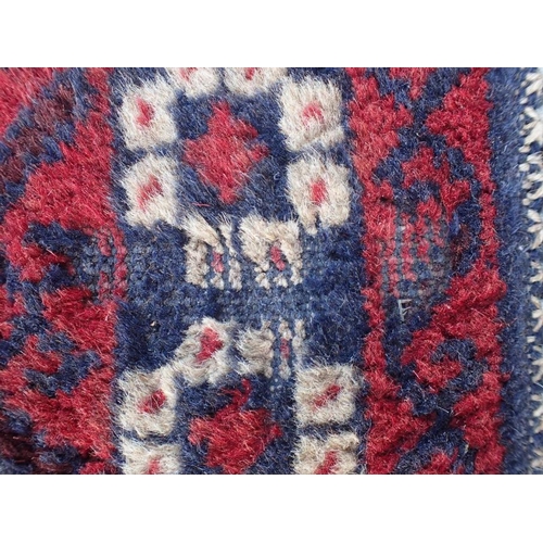 866 - TWO BELOUCHI RUGS EACH WITH LOZENGE MEDALLIONS 140 x 86cm and 136 x 80cm (both moth damaged) (2)