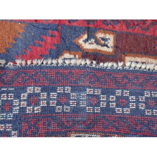 866 - TWO BELOUCHI RUGS EACH WITH LOZENGE MEDALLIONS 140 x 86cm and 136 x 80cm (both moth damaged) (2)