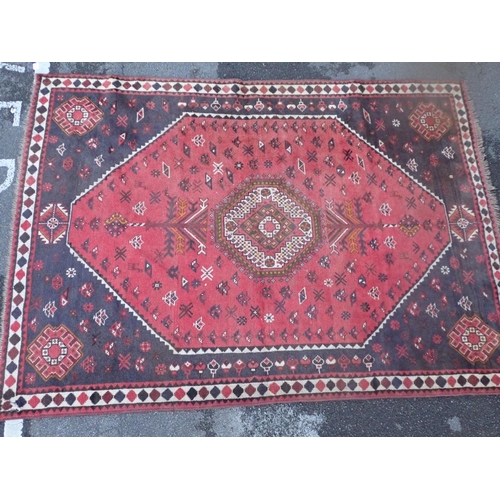 867 - A MODERN BERBER STYLE CARPET with central medallion and twin tree of life motifs on a red ground 292... 