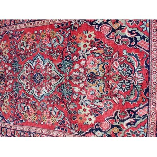 870 - A HAMADAN RUG woven in colours with lozenge central medallion, floral filler motifs and spandrels on... 