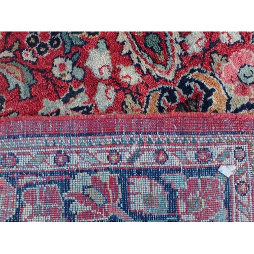 870 - A HAMADAN RUG woven in colours with lozenge central medallion, floral filler motifs and spandrels on... 