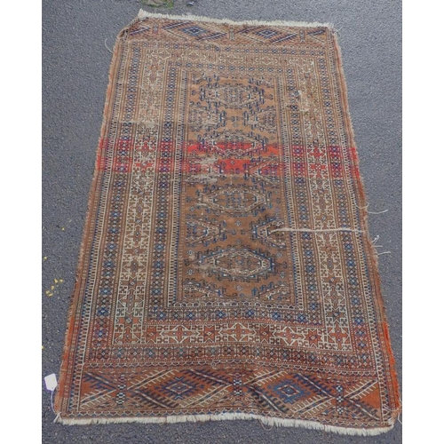 876 - AN OLD TURKMAN RUG red ground, with blue and cream 108 x 175cm approx (worn, holed, uneven colour) P... 