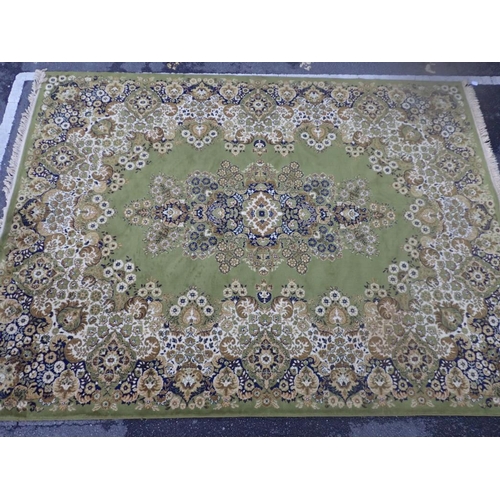 878 - A LARGE GREEN GROUND CARPET 355 x 277cm