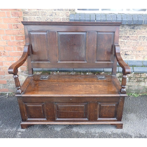 889 - A GEORGE I STYLE OAK HALL BENCH the seat with butterfly hinges, the front and back with fielded pane... 