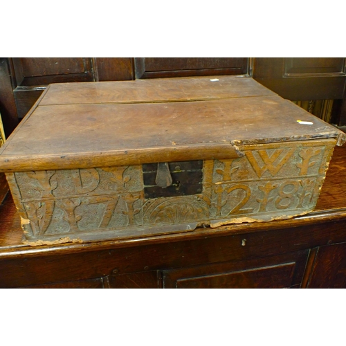 890 - AN ELM BIBLE BOX, WITH CARVED INITIALS, DATED 1728 and lined with Victorian prints 58cm wide (woodwo... 