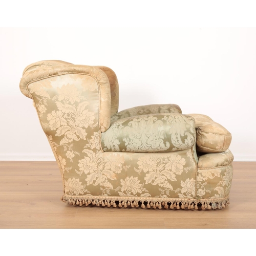 956 - AN EDWARDIAN STYLE 'COUNTRY HOUSE' WING BACK ARMCHAIR with deep seat, upholstered in green leaf dama... 