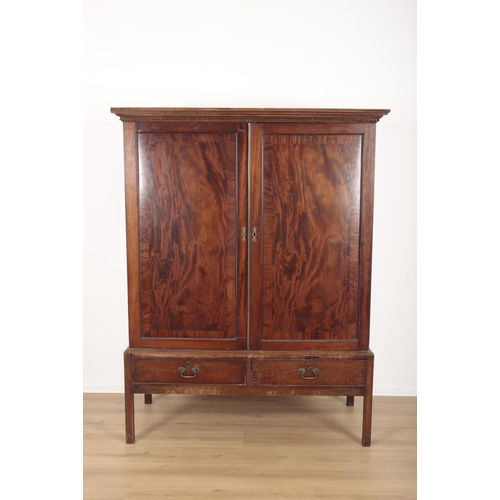 970 - A MAHOGANY LINEN PRESS the upper section with dentil moulded cornice over crossbanded cupboard doors... 