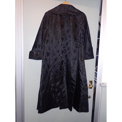 9 - YING TAI CO, HONG KONG: 1950S LADIES BLACK SILK COAT embroidered with good luck motifs and with blue... 