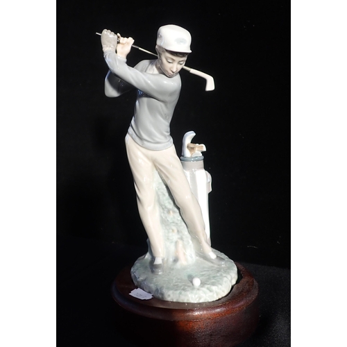 96 - LLADRO: A GOLFING FIGURE, ON WOODEN STAND 31cm high, inclusive, with two other Lladro items and a fu... 