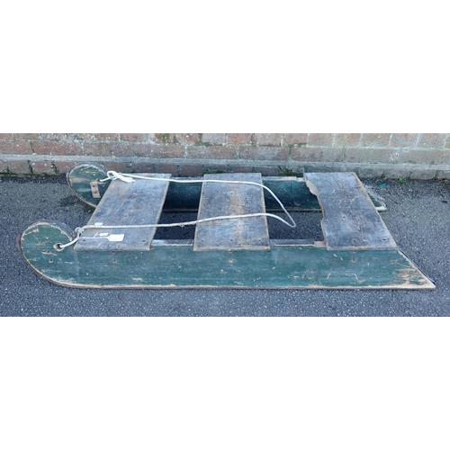 124 - A PAINTED TOBOGGAN, WITH HEAVY IRON RUNNERS and original painted surface 125cm long (some damage, mi... 